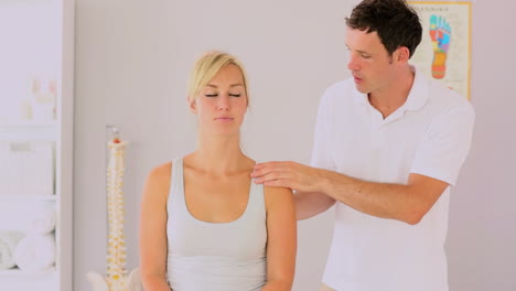 Physiotherapist-checking-his-patients-back