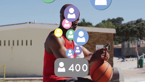 holding basketball and phone, man with animation of social media icons and followers