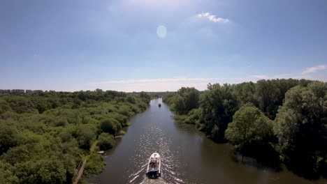 Aerial-Drone-Footage-of-a-boat-along-the-River-Waveney,-Norfolk