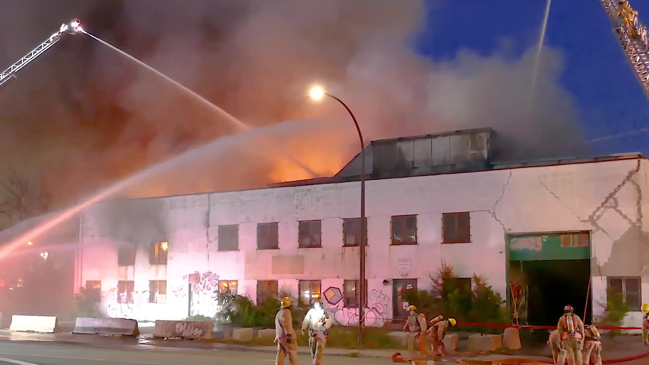 Massive Fire Engulfs Building at Night; Firefighters Battle Blaze