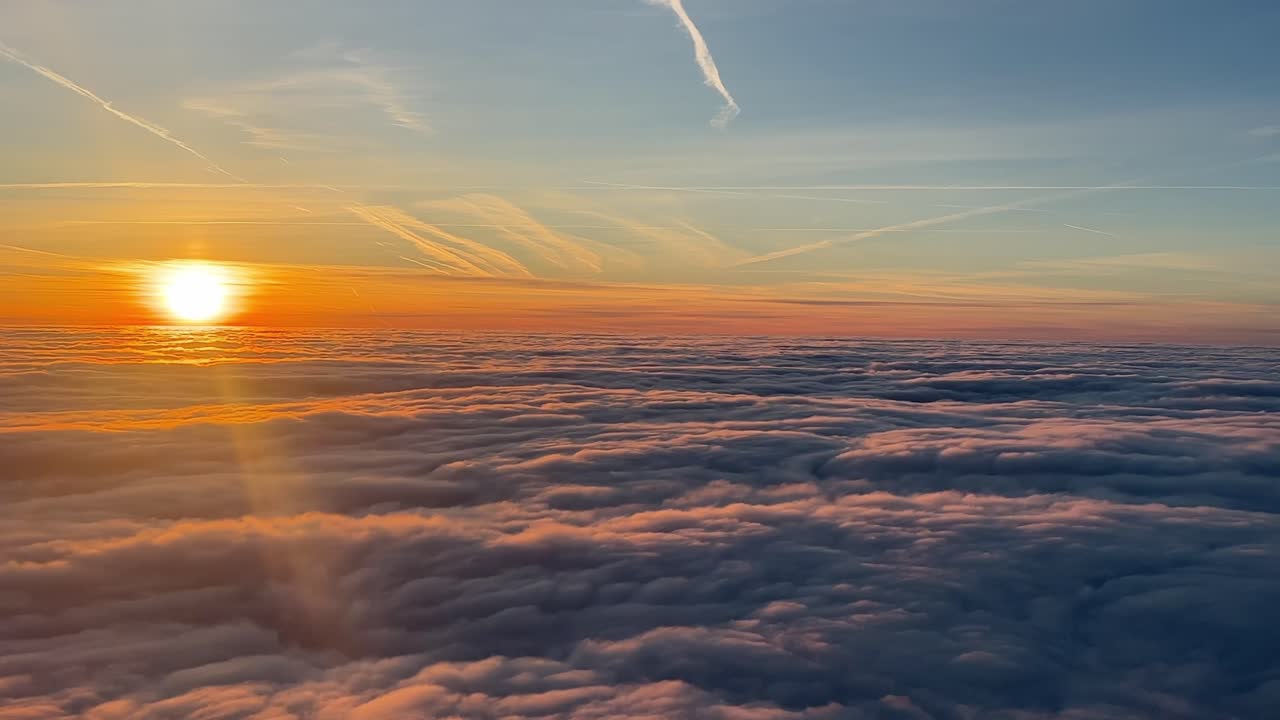 Alba su un mare di nuvole: una vista mozzafiato dalla cabina di pilotaggio di un jet in rapido volo