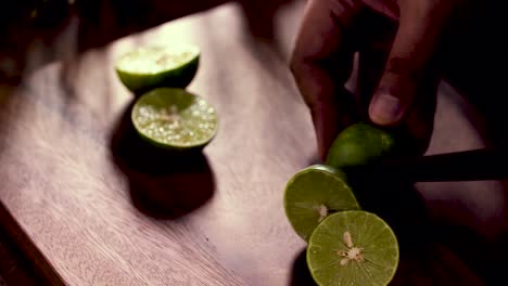 Hand-use-Knife-to-Cut-Lime-in-Half,-Close-Up,-Set-up