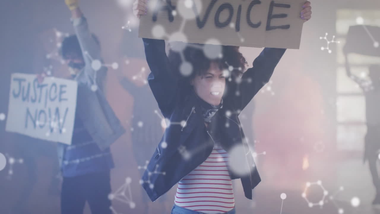 Protesters raising signs indoors, showcasing technology-driven activism with molecular overlays