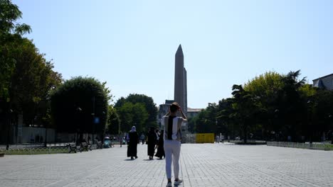 Young-man-taking-photo-obelisk