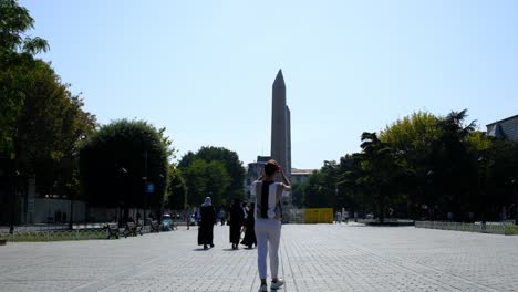 young man taking photo obelisk