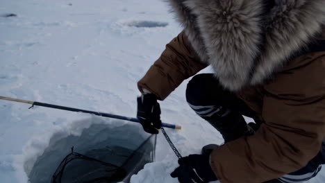 ice fishing on a frozen lake