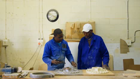 male workers using digital tablet in workshop 4k