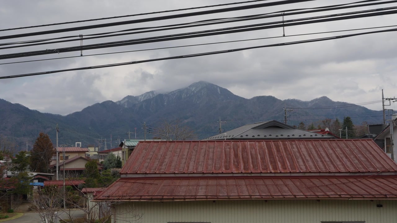 Mountain view with red rooftops and power lines in Fujiyoshida Yamanashi Japan