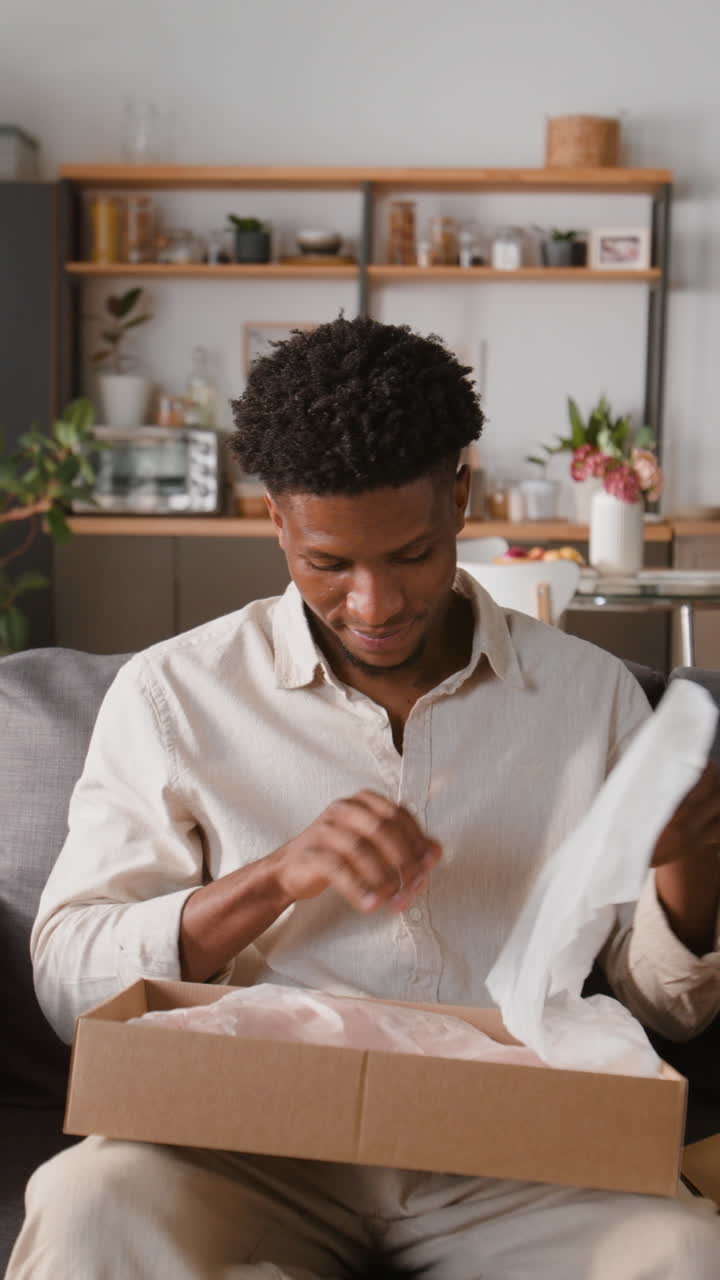 Man unboxing a package at home