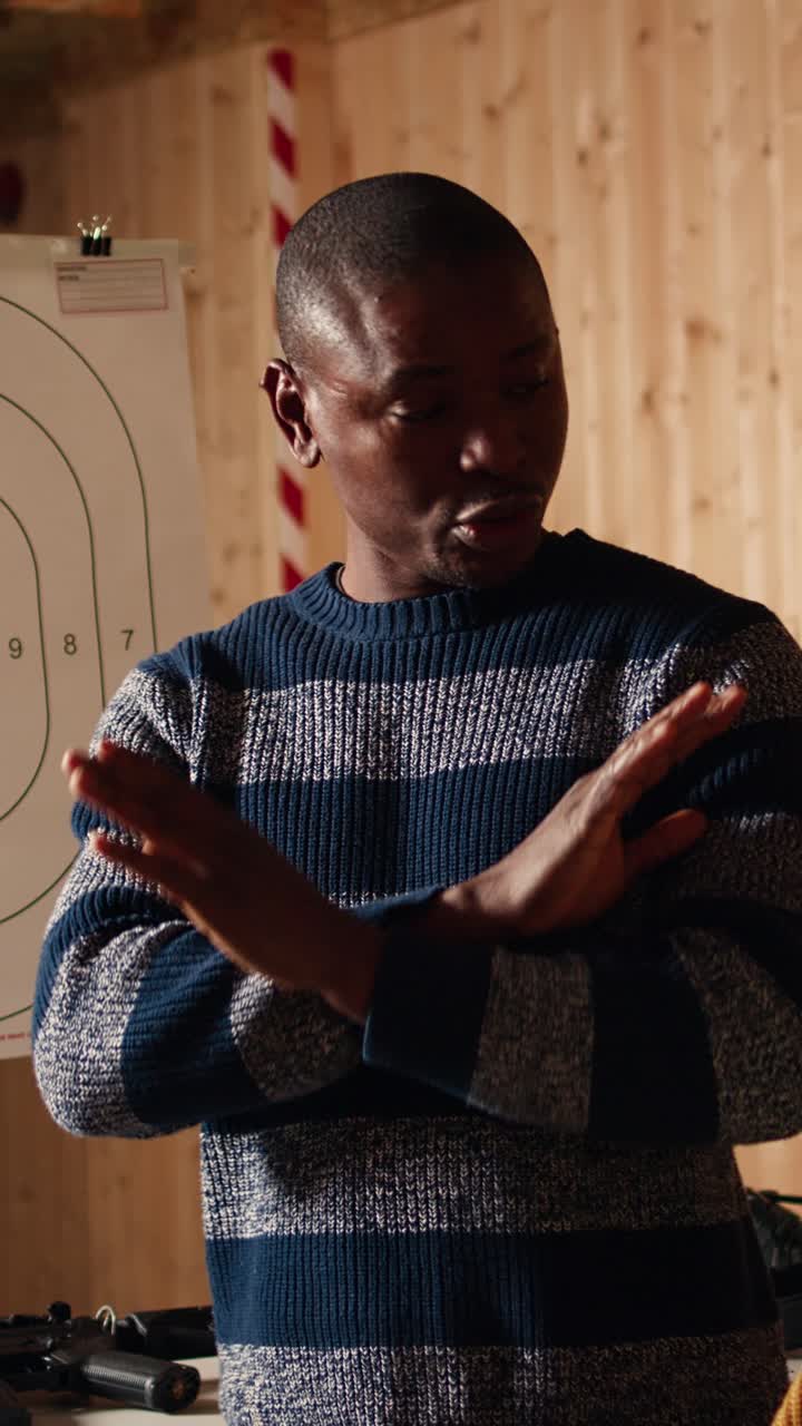 Vertical video Shooting range safety officer ensuring clients are following rules