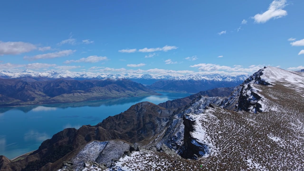 Aerial view over Lake Hawea and snow-dusted mountain ridge in Central Otago, NZ