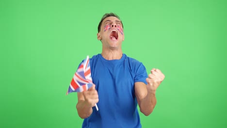 Man cheering for United Kingdom screaming and waving a national flag