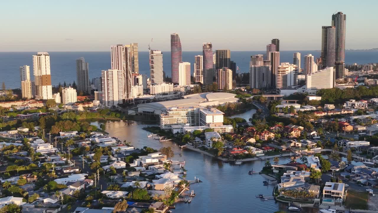 Drone footage captures Gold Coast's skyline and waterways during sunset, highlighting urban architecture and natural beauty