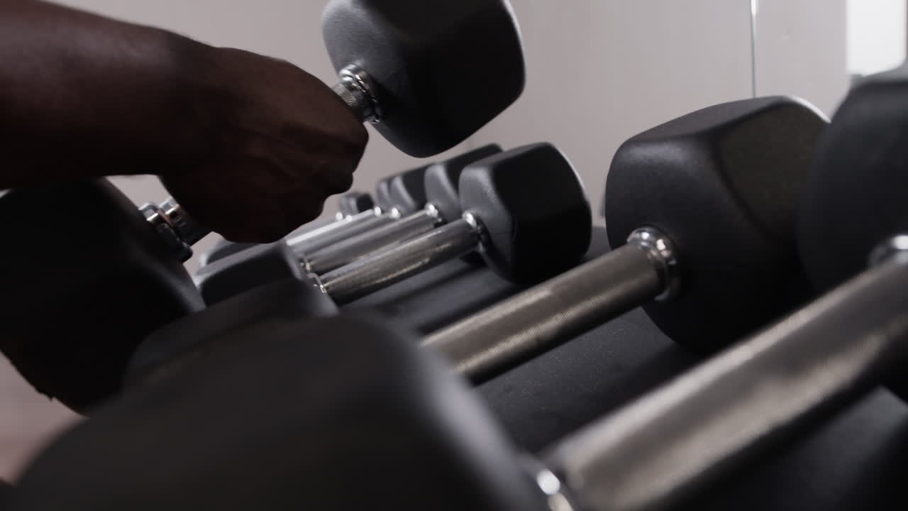Person using dumbbells in a gym