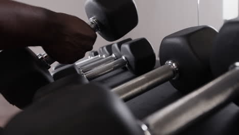 person using dumbbells in a gym