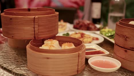 a rotating table displays dim sum, duck, and various dishes in a warm, inviting restaurant setting