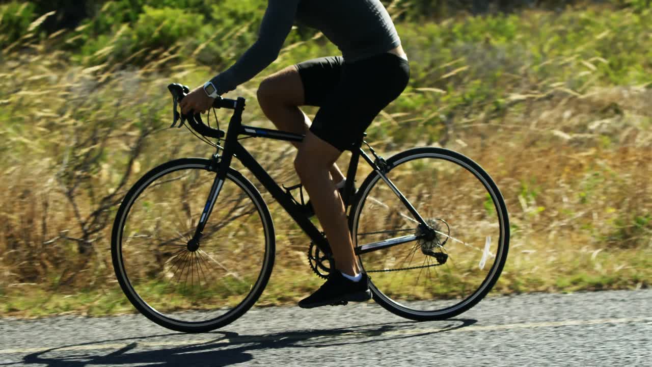 Triathlete man cycling in the countryside road