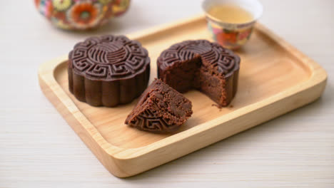 chinese moon cake dark chocolate flavour on wood plate