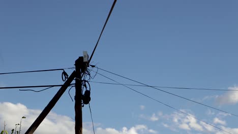 Timelapse Of Clouds In The Background With An Electricity Pole In Focus