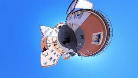 little tiny planet 360 small world view of a man walking near medieval buildings in germany in 4k