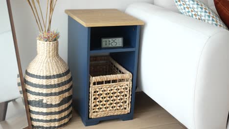 stylish navy blue side table with rattan basket and digital clock