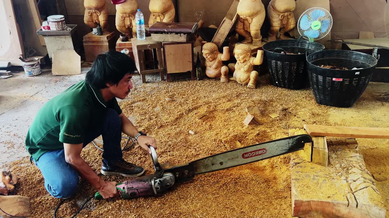 Wood Carver Using Chainsaw and Angle Grinder to Create Wooden Statues