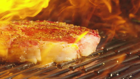 ribeye steak cooking on a flaming grill