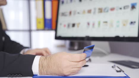 Male-man-making-purchase-with-credit-card-in-online-store.