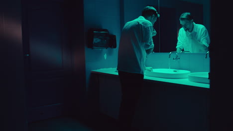 man in a bathroom at night