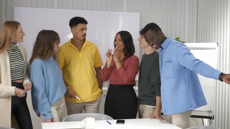 happy multi-ethnic business team applauding in office meeting