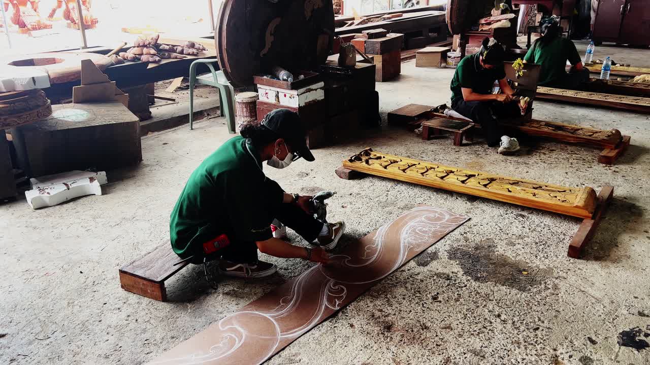 Thai Women Artisans Skillfully Carving Intricate Wooden Designs