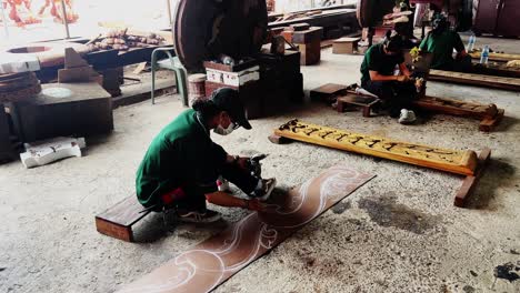 thai women artisans skillfully carving intricate wooden designs