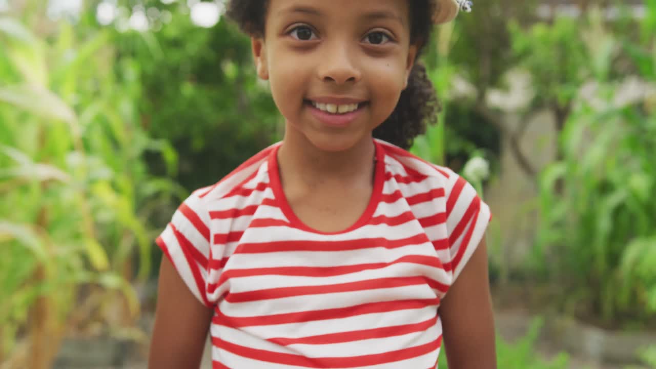 African American girl showing potatoes at the camera