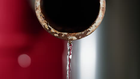 water draining from rusty pipe