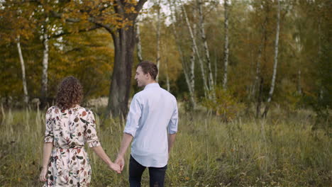 Loving-Couple-Walking-On-A-Meadow-In-Summer-11