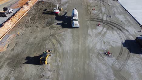 A-concrete-truck-drives-toward-a-concrete-pouring-site