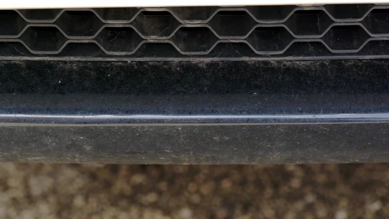 Close up of a dirty black bumper and lower grill