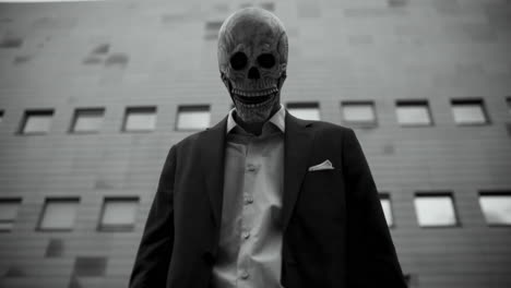 man in skull mask business suit