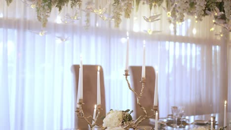 elegant wedding table setting with candles and flowers