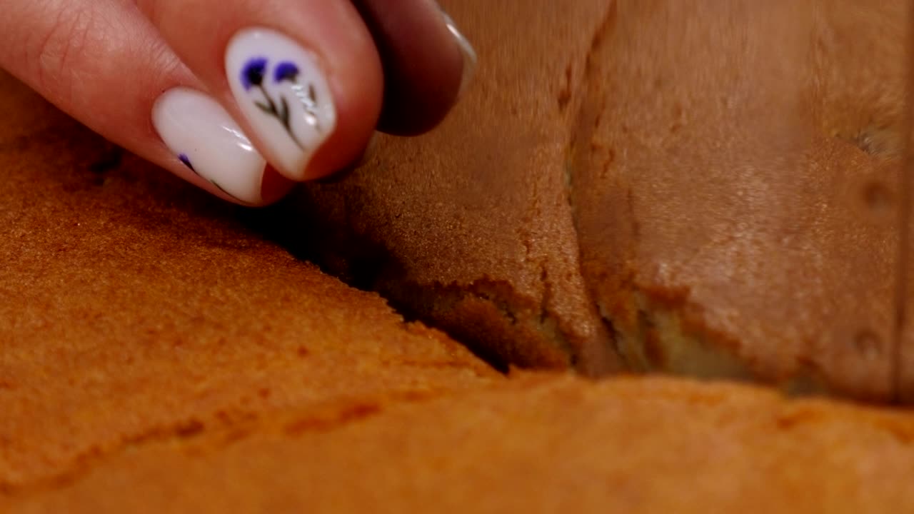 Close-up of a pastry chef cuts a round shape from a biscuit dough for a cake.