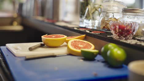 chopped-up-oranges-and-limes-on-a-cutting-board-in-a-bar