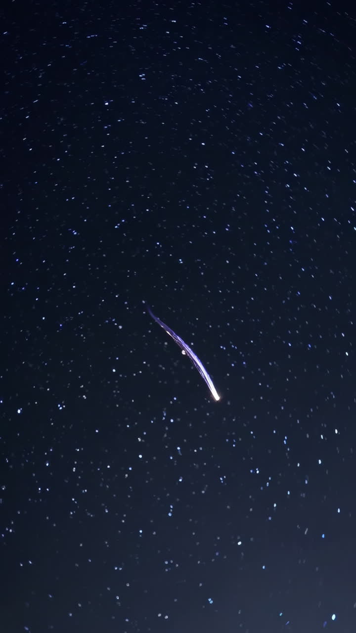 Meteor Streaking Across a Starry Night Sky
