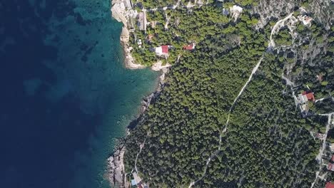 Forward,-slow-motion,-slightly-rotating,-straight-down-drone-shot-over-the-island-of-Aigina-in-Greece