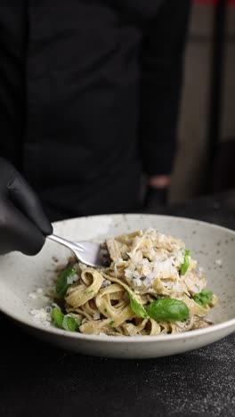 chef serving creamy mushroom tagliatelle