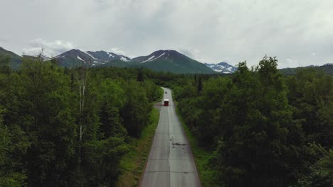 travel tour trolley bus approaching from countryside road in anchorage, alaska