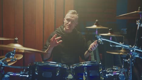 drummer checking phone in music studio