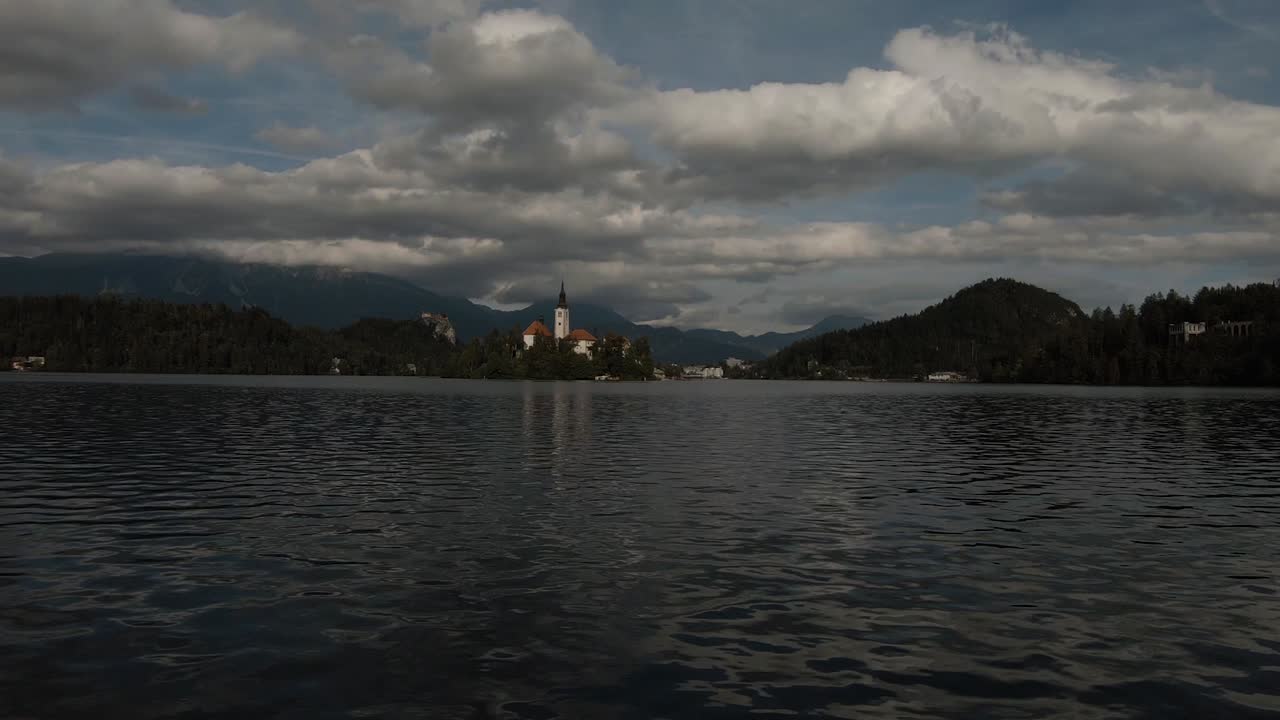 Steady shot of the Lake Bled island taken on a partly cloudy summer day