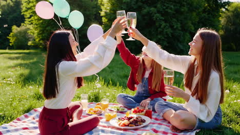 friends enjoying a picnic and toasting in a sunny park
