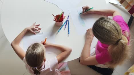 mother and daughter drawing together