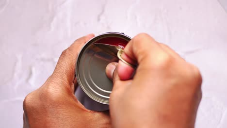 opening and examining a can of tomato products